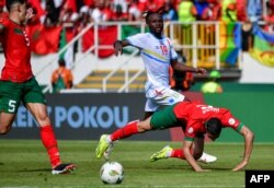 FILE - DR Congo's forward #19 Fiston Mayele (C) fights for the ball with Morocco's defender #2 Achraf Hakimi (R) and Morocco's defender #5 Nayef Aguerd (L) during the Africa Cup of Nations (CAN) 2024 group F football match between Morocco and DR Congo at Stade L