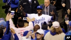 Lorenzo Cain celebra con los aficionados el triunfo por paliza en el sexto juego de la Serie Mundial contra los Gigantes de San Francisco.
