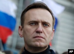 In this Feb. 29, 2020, file photo, Russian opposition activist Alexei Navalny takes part in a march in memory of opposition leader Boris Nemtsov in Moscow, Russia. Navalny has been poisoned and hospitalized on Thursday morning, Aug. 20, 2020…