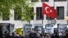FILE - Marking the World Press Freedom Day, activists with Reporters Without Borders hold posters with portraits of journalists detained in Turkey, to protest against the situation for media in the country, in front of the Turkish embassy in Berlin, May 3, 2017.