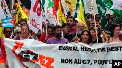 People hold a banner reading "No G7" during a demonstration in Biarritz, southwestern France, July 13, 2019. 