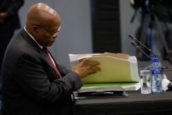 Former South African president Jacob Zuma leafs through documents as he testifies before a state commission probing wide-ranging allegations of corruption in government and state-owned companies, in Johannesburg, South Africa, July 17, 2019.