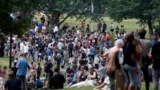 People assemble on Boston Common before a planned "Free Speech" rally by conservative organizers begins, Aug. 19, 2017, in Boston. 