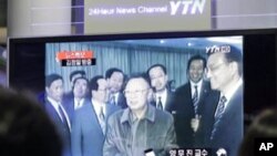 People watch file footage of North Korean leader Kim Jong Il broadcast on a TV screen in the Seoul train station in Seoul, South Korea. South Korean news agencies reported that Kim Jong Il traveled Friday to his country's key ally and benefactor China, Ma