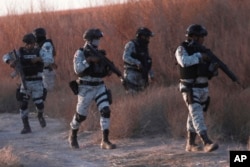 FILE - Mexican national guard members patrol along the Mexico-U.S. border in Ciudad Juarez, Feb. 5, 2025.