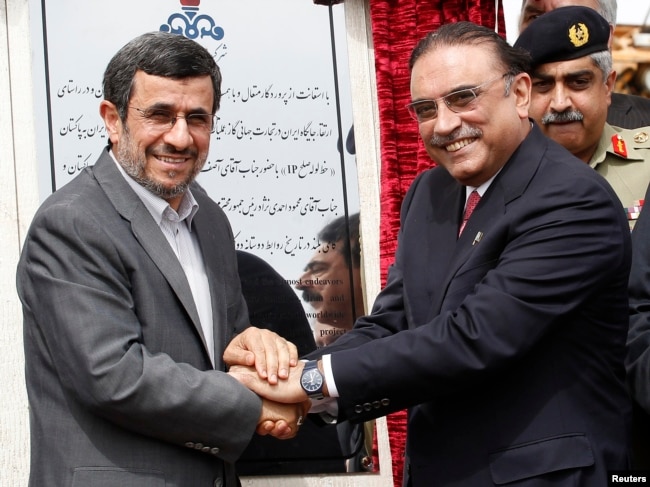 FILE - Iran's President Mahmoud Ahmadinejad (left) shakes hands with his Pakistani counterpart Asif Ali Zardari, during a groundbreaking ceremony to mark the start of construction of the Iran-Pakistan gas pipeline, in Chahbahar, Iran, March 11, 2013.
