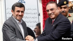 Iran's President Mahmoud Ahmadinejad (L) shakes hands with his Pakistani counterpart Asif Ali Zardari, during a groundbreaking ceremony to mark the start of construction of the Iran-Pakistan gas pipeline, Mar. 11, 2013.