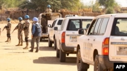 Members of the United Nations and African Union peacekeeping mission (UNAMID) gather with their vehicles in Kalma camp for internally displaced people in Nyala, the capital of South Darfur, Dec. 31, 2020. 
