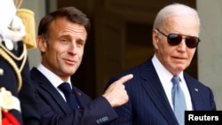 French President Emmanuel Macron gestures next to U.S. President Joe Biden at the Elysee Palace in Paris, France, on June 8, 2024.