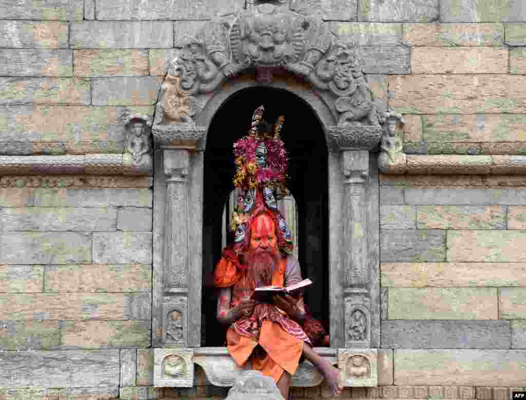 A Hindu Sadhu (holy man) sits on the premises of the Pashupatinath temple in Kathmandu, Nepal.
