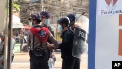 In this image made from video taken on Feb. 27, 2021, Associated Press journalist Thein Zaw is arrested by police in Yangon, Myanmar. Authorities charged Thein Zaw and other members of the media with violating a public order law.