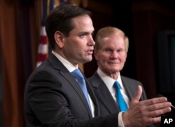 Sen. Marco Rubio, R-Fla., joined at right by Sen. Bill Nelson, D-Fla., holds a news conference to unveil his plan to address gun violence with legislation on restraining orders, at the Capitol in Washington, March 7, 2018.