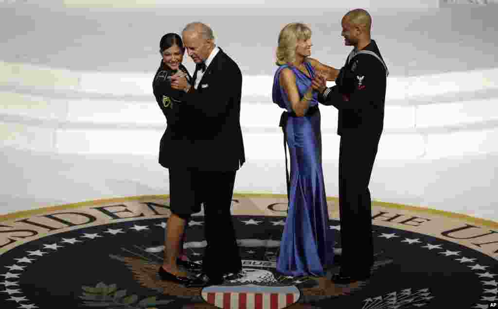 Vice President Joe Biden dances with Army Staff Sgt. Keesha Dentino as Jill Biden dances with Navy Petty Officer 3rd Class Patrick Figueroa during the Commander-In-Chief inaugural ball, January 21, 2013.