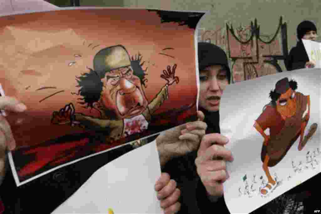Demonstrators hold depictions of Libyan leader Moammar Gadhafi during a protest against the Libyan regime's crackdown on protestors, in front of the Libyan Embassy, Sarajevo, Bosnia, Wednesday, Feb. 23, 2011. (AP Photo/Sulejman Omerbasic)