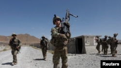 FILE - U.S. troops patrol at an Afghan National Army base in Logar province, Afghanistan, Aug. 7, 2018.