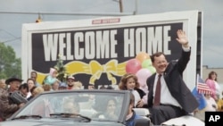 FILE - In this June 22, 1992 file photo, former hostage Terry Anderson waves to the crowd as he rides in a parade in his honor in Lorain, Ohio. 