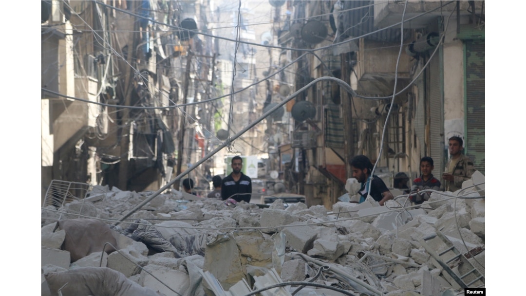 FILE - People inspect a site hit by an airstrike in the rebel-held area of Aleppo's al-Sukari district, Syria, May 30, 2016.