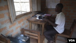 Severin Bavulo, a high frequency radio operator in Zemio, provides security information over the radio to surrounding communities. (VOA/Z. Baddorf)