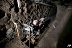 A motorcycle adapted to a rail sits in the tunnel under the half-built house where according to authorities, drug lord Joaquin "El Chapo" Guzman made his escape from the Altiplano maximum security prison in Almoloya, west of Mexico City, July 14, 2015.