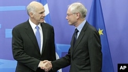 European Council President Herman Van Rompuy, right, welcomes Greek Prime Minister George Papandreou at the European Council building in Brussels, June 20, 2011