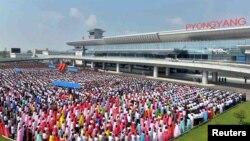 People attend the opening ceremony for the newly built terminal of Pyongyang International Airport in this undated picture released by North Korea's Korean Central News Agency (KCNA), July 1, 2015. 
