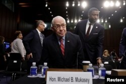 Former U.S. attorney general Michael Mukasey takes a seat before a Senate Judiciary Committee nomination hearing for William Barr to be attorney general of the U.S., on Capitol Hill in Washington, Jan. 16, 2019.