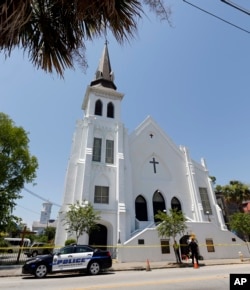 Two Charleston police officers stand in front of the Emanuel AME Church following a shooting Wednesday night in Charleston, S.C., June 18, 2015.