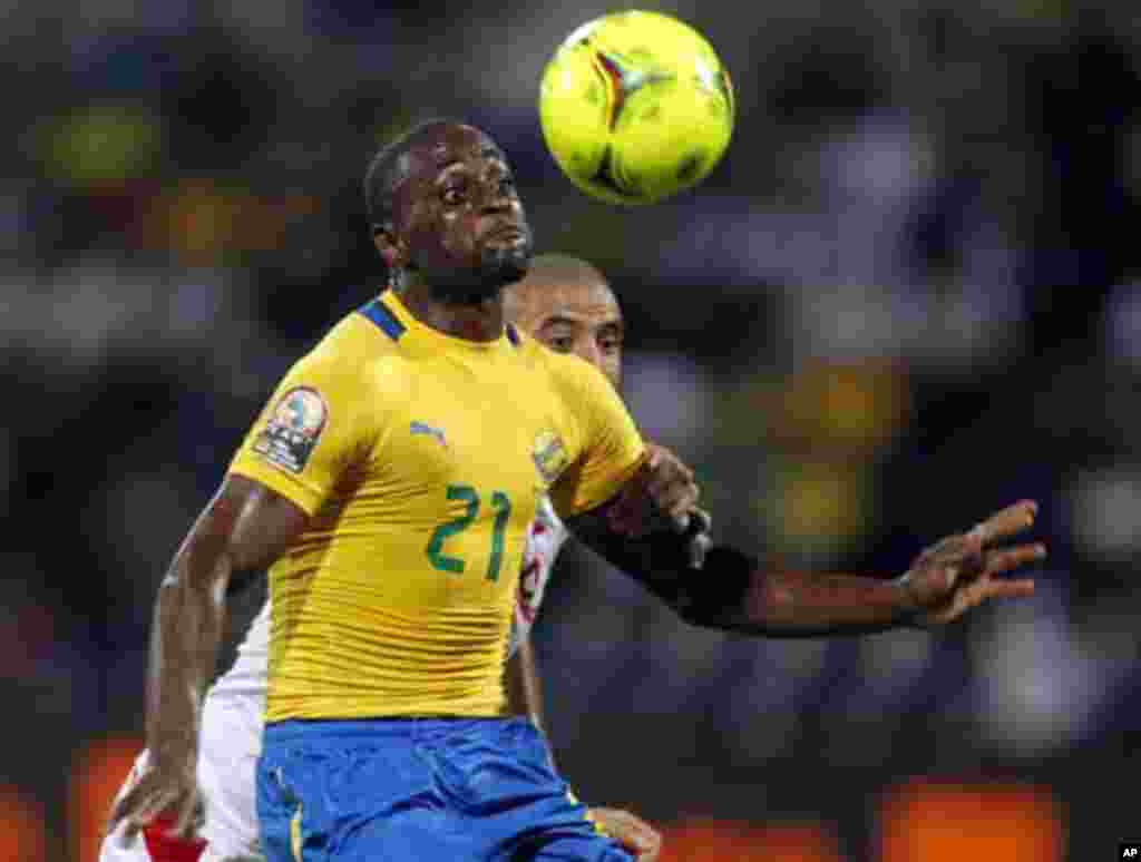 Gabon's Roguy Meye (R) challenges Aymen Abdennour of Tunisia during their African Cup of Nations Group C soccer match at Franceville stadium in Gabon January 31, 2012.