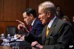 Sen. Marco Rubio, R-Florida, left, listens as Sen. Bill Nelson, D-Florida, speaks during a Senate Judiciary Committee hearing on the Parkland, Florida, school shootings and school safety, March 14, 2018, on Capitol Hill in Washington.
