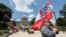 Supporters of the current Mississippi state flag stand outside the state Capitol in Jackson, Mississippi, June 28, 2020.