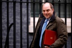 FILE - Britain's Defense Secretary Ben Wallace walks outside Downing Street in London, Britain, Feb. 3, 2021.