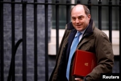 FILE - Britain's Defense Secretary Ben Wallace walks outside Downing Street in London, Britain, Feb. 3, 2021.