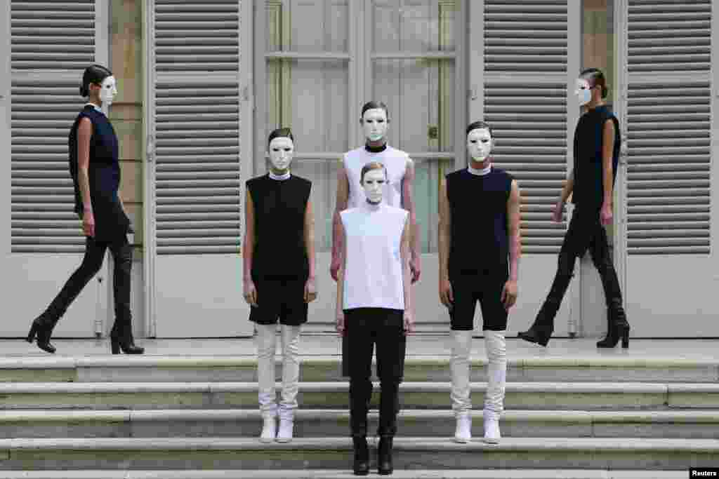 Models present creations by Jordan-born designer Rad Hourani as part of his Haute Couture Fall Winter 2013/2014 fashion show in Paris, France.