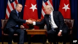 FILE - U.S. President Donald Trump shakes hands with Turkish President Recep Tayyip Erdogan during a meeting at the Palace Hotel during the United Nations General Assembly in New York, Sept. 21, 2017.