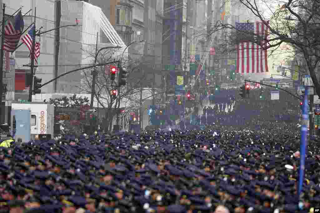 New York Police officers gather along Fifth Avenue for the funeral of Officer Jason Rivera, outside St. Patrick&#39;s Cathedral in New York. Rivera and his partner, Officer Wilbert Mora, were fatally wounded when a gunman ambushed them last week.