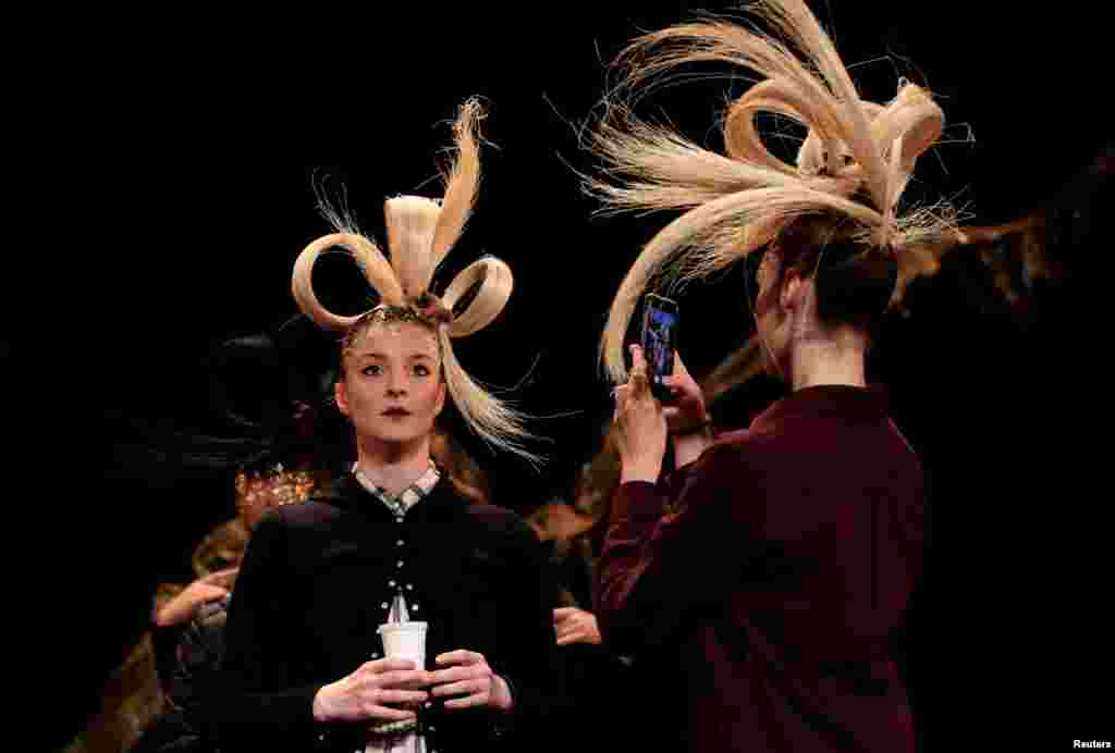 A model takes pictures during a rehearsal before the Haute Couture Spring-Summer 2019 collection show by designer Franck Sorbier in Paris, France.