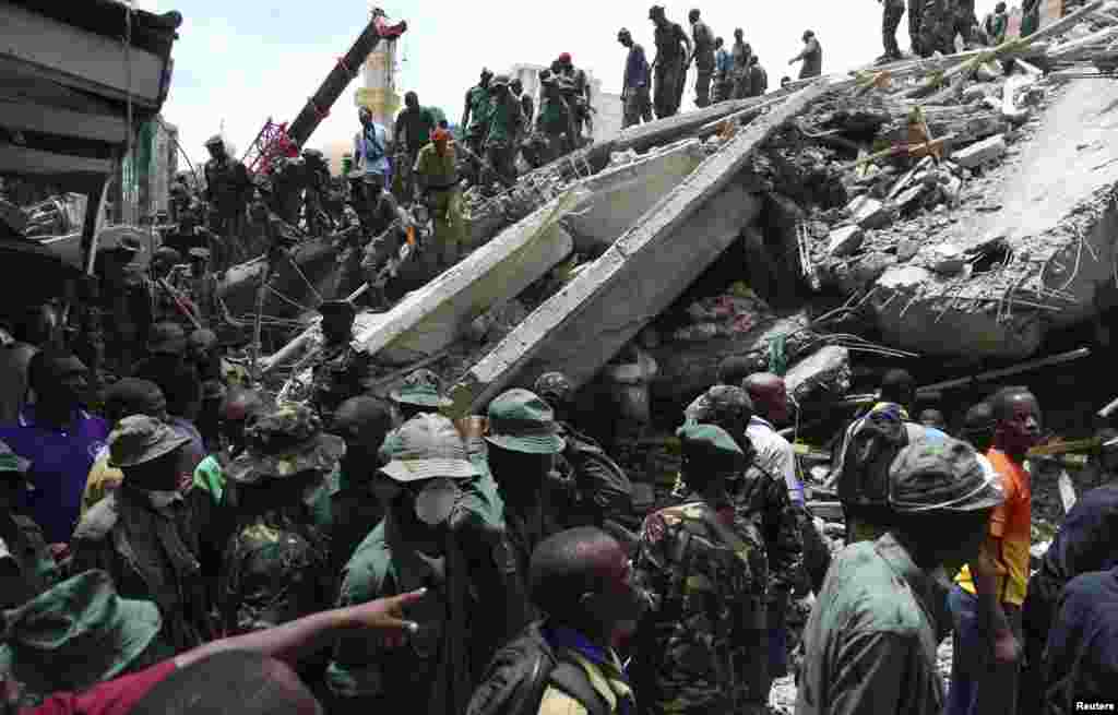 Rescuers search for survivors in the rubble of a collapsed building in the Kariakoo district of central Dar es Salaam, Tanzania, March 29, 2013.