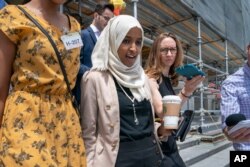 Rep. Ilhan Omar, D-Minn., a target of racist rhetoric from President Donald Trump, walks from the House to her office following votes, at the Capitol in Washington, July 18, 2019.