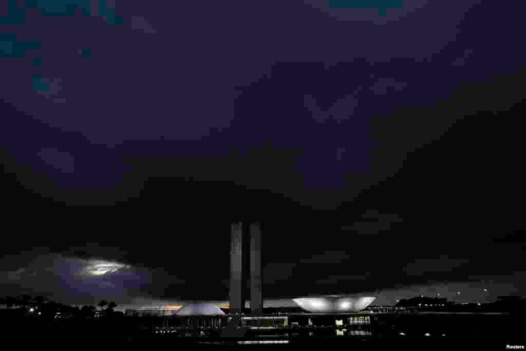 Clouds are seen above Brazil's National Congress headquarters before heavy rains in Brasilia.