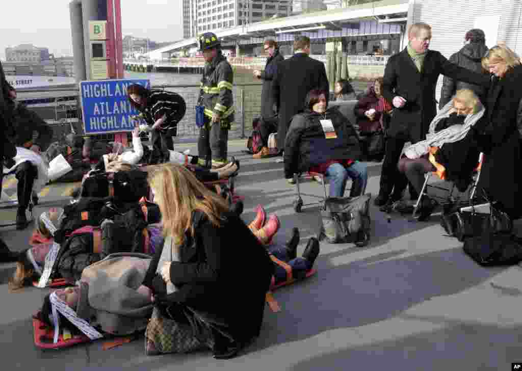 Injured passengers of the Seastreak Wall Street ferry are aided, in New York. The ferry from Atlantic Highlands, New Jersey, banged into the mooring as it arrived at South Street in lower Manhattan during morning rush hour, injuring as as many as 50 people, officials said.