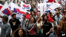 Supporters of the communist-affiliated union PAME chant slogans during an anti-austerity rally in Athens, Greece, May 22, 2016.