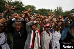 FILE - Demonstrators protest gesture during Irreecha, the thanksgiving festival of the Oromo people, in Bishoftu town, Oromia region, Ethiopia. More than 50 people were killed in the violence.
