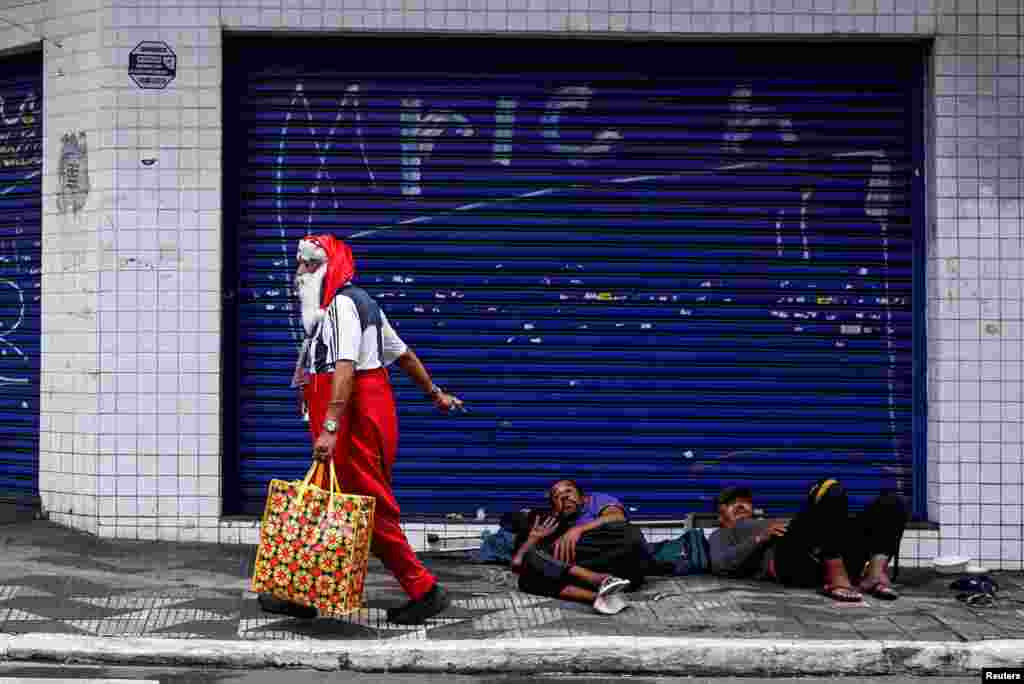 A man dressed as Santa Claus, who identifies as &quot;Sultan Das Matas,&quot; walks, in Sao Paulo, Brazil, on December 9, 2024.