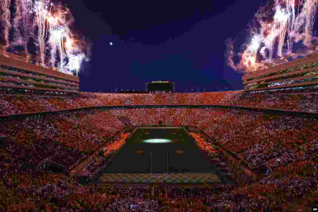 Fans dressed in orange and white form the checkerboard pattern in Neyland Stadium as fireworks explode before an NCAA college football game against Mississippi, Oct. 16, 2021, in Knoxville, Tennessee.