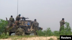 FILE - Afghan soldiers fire a machine gun during a gun battle with Taliban forces in Afghanistan's northern Baghlan province, April 15, 2010. On Tuesday, the Taliban captured the province's Tala Wa Barfak district as part of its latest "spring offensive."