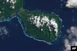 This satellite photo shows the southern part of the French Polynesian island of Tahiti, with the Olympic venue Teahupo'o at center on the southern coast. (NASA's Earth Observatory via AP)