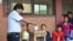 Bolivia's President Evo Morales, left, casts his ballot at a polling station in Villa 14 de Septiembre, in the Chapare region, Bolivia, Sunday, Feb. 21, 2016.