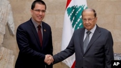 In this photo released by Lebanon's official government photographer, Dalati Nohra, Venezuelan Foreign Minister Jorge Arreaza shakes hands with his Lebanese counterpart, Gebran Bassil, in Beirut, Lebanon, Apr. 3, 2014. 