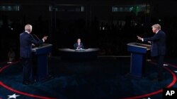 FILE - President Donald Trump and Democratic presidential candidate former Vice President Joe Biden participate in the first presidential debate, at Case Western University and Cleveland Clinic, in Cleveland, Sept. 29, 2020.