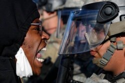 Protesters and National Guardsmen face off on East Lake Street, May 29, 2020, in St. Paul, Minn.